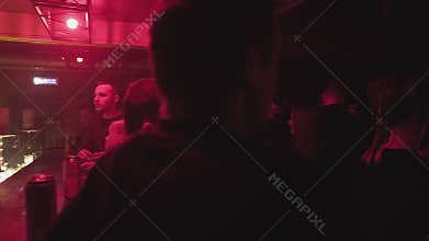 RUSSIA, VLADIMIR, 02 OCT 2021: customer pays barman for drinks at nightclub bar