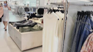 Fashion, retail and shopping concept, assortment of stylish clothes on hangers in apparel clothing store