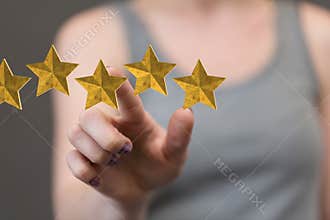 Female giving a virtual 5-star review - feedback, review, and rating concepts