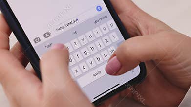 Female hands typing text on smartphone close-up. Using smartphone close up at work. Unknown person hands using cellphone