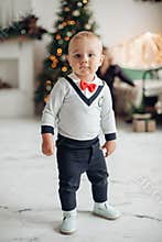 Stylish baby boy looking at camera.