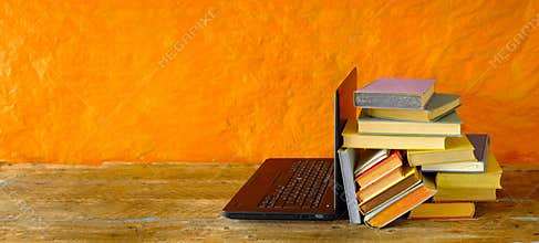 Home office,education,business,concept with laptop computer and heap of books, free copy space