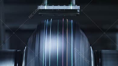 Closeup rubber tire manufacturing machine spinning in automotive manufacture
