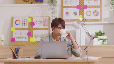Working man holding cup enjoy favorite tea drink or coffee beverage while sitting at desk in modern living room before start work