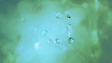 Steam and water droplets. Splashes of water and neon fog. Smoke and water bubbles, top view. Chemistry, science, alchemy. Air humi