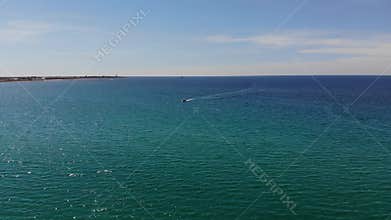 The transparent surface of the sea and algae with stones under its surface. Aerial view of ocean surface