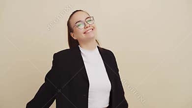 Joyful woman on beige background shows shape of heart with hand gestures