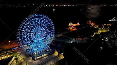 Night panoramic landscape of illuminated ferris wheel at Rio de Janeiro Brazil