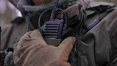 Close-up walkie-talkie with unrecognizable Caucasian young man pressing button talking. Confident courageous male