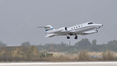 Luxury business jet used by United States Air Force take off in grey cloudy day