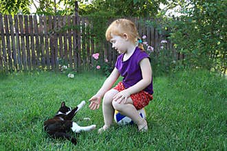 Cheerful red-haired girl and a cat are happy together