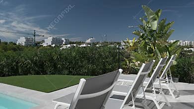 White empty deck chairs in row near swimming pool