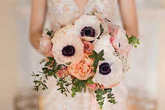 Elegant wedding bouquet with flowers in pastel peach colors
