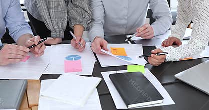 Close up diverse business people analyzing research information.