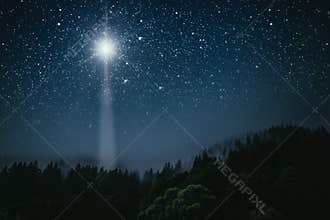 A The star shines over the manger of christmas of Jesus Christ
