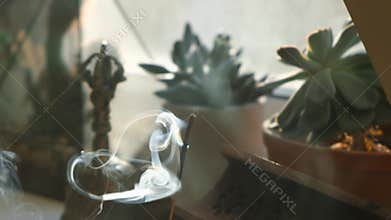 Incense stick smoke in slow motion close up