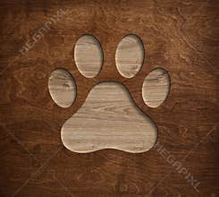 Pet paw print dog cat symbol engraved in wooden board
