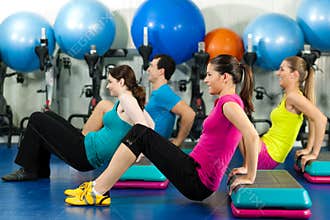 People in gym on step board
