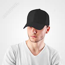 Mockup of a black baseball cap on a guy`s head, looking from under a visor, front view, empty panama for design presentation