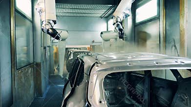 Automotive painter robots painting a car body