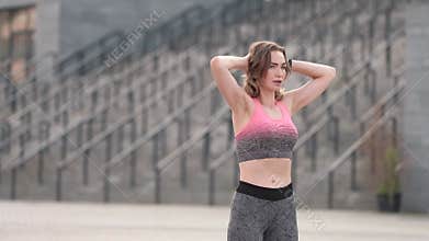 Slim fit adult woman exercise on an outdoor workout training alone. Summer sunset morning portraits in action on a european