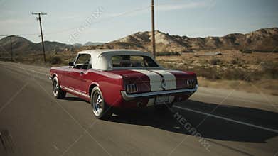 Old Mustang Car driving on Scenic Highway in California surrounded by Desert, Tracking follow shot