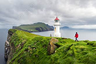 Foggy view of old lighthouse on the Mykines island