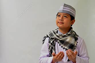 asian muslim boy with praying expression, suitable for ramadhan kareem