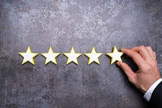 Person Placing Five Star Rating Icon