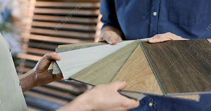 Interior design shop salesman showing material samples to customer