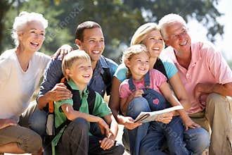 Three generation family resting on a country walk