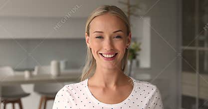 Portrait of beautiful woman standing indoors looking at camera