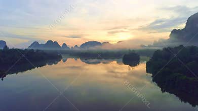 Amazing clouds of dense fog move flowing over mountain sunrise or sunset sky fog scenic aerial view. Drone flies over sky