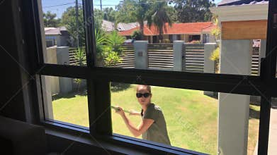 Adult woman cleaning house windows