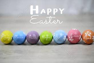 Happy Easter. Bright and colorful Easter eggs lined up horizontally on a white wooden background. Easter egg with kind words.