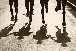 Running race sports background. athletes running on road.