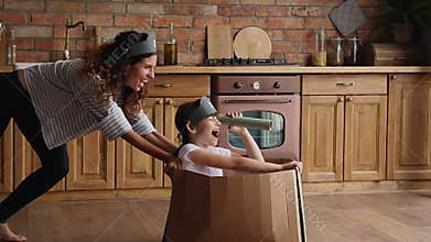 Mother and daughter play game in cozy modern kitchen