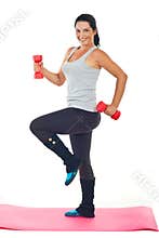Happy woman doing fitness with barbell