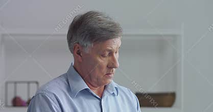 Portrait of elderly mature business man gray-haired pensioner grandfather puts on blue shirt stylish clothes getting