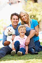 Couple in city park with son and dog