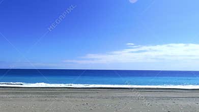 POV-Passenger side window driving scene. blue ocean against  blue sky