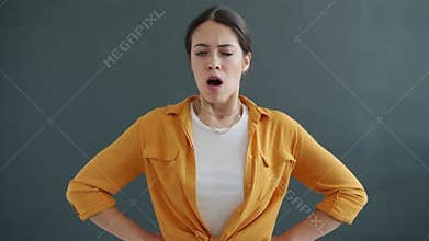 Angry young lady getting bad news opening mouth and looking at camera with disagreement