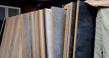 Person looking at laminate material samples at interior design shop