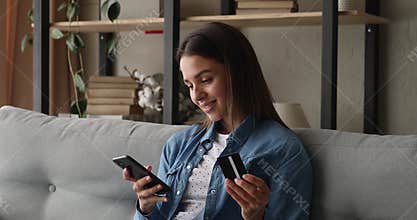 Happy young woman enjoying shopping in mobile application.