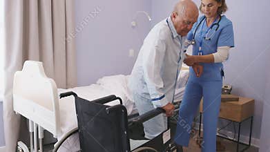 Nurse helping senior patient at clinic