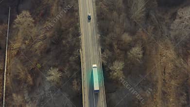 Logistics concept: transportation and delivery of goods on a truck with a semi-trailer - aerial shot