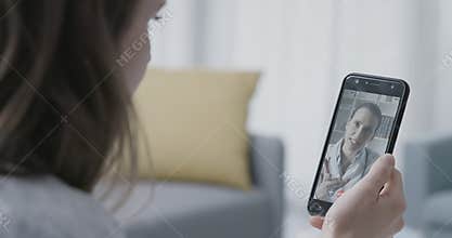 Woman video calling her online doctor