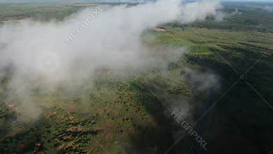 Clouds over a green landscape