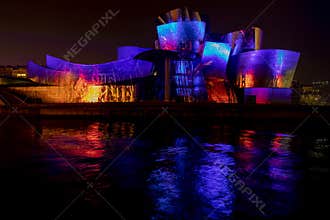 Multicolored show on the facade of the Guggenheim Bilbao museum.