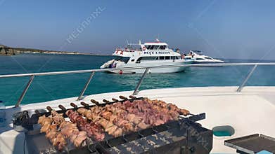 BBQ on the Boat. Blue cruise tour along Gocek in Turkey. When captain rang the bell, we would gather around the table at